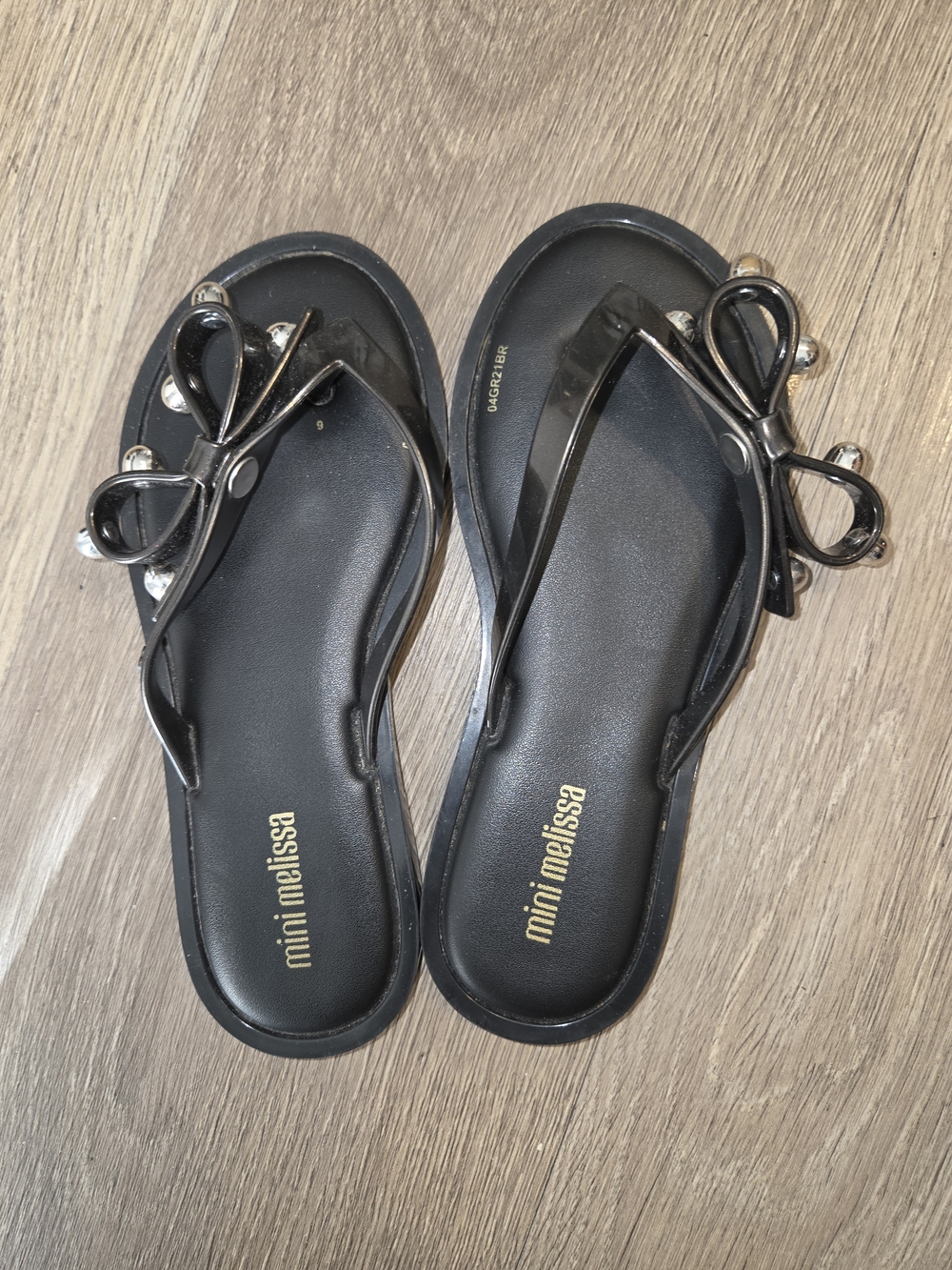 Mini Melissa Black Jelly Bow Flip Sandals with Silver Accent Ornaments
